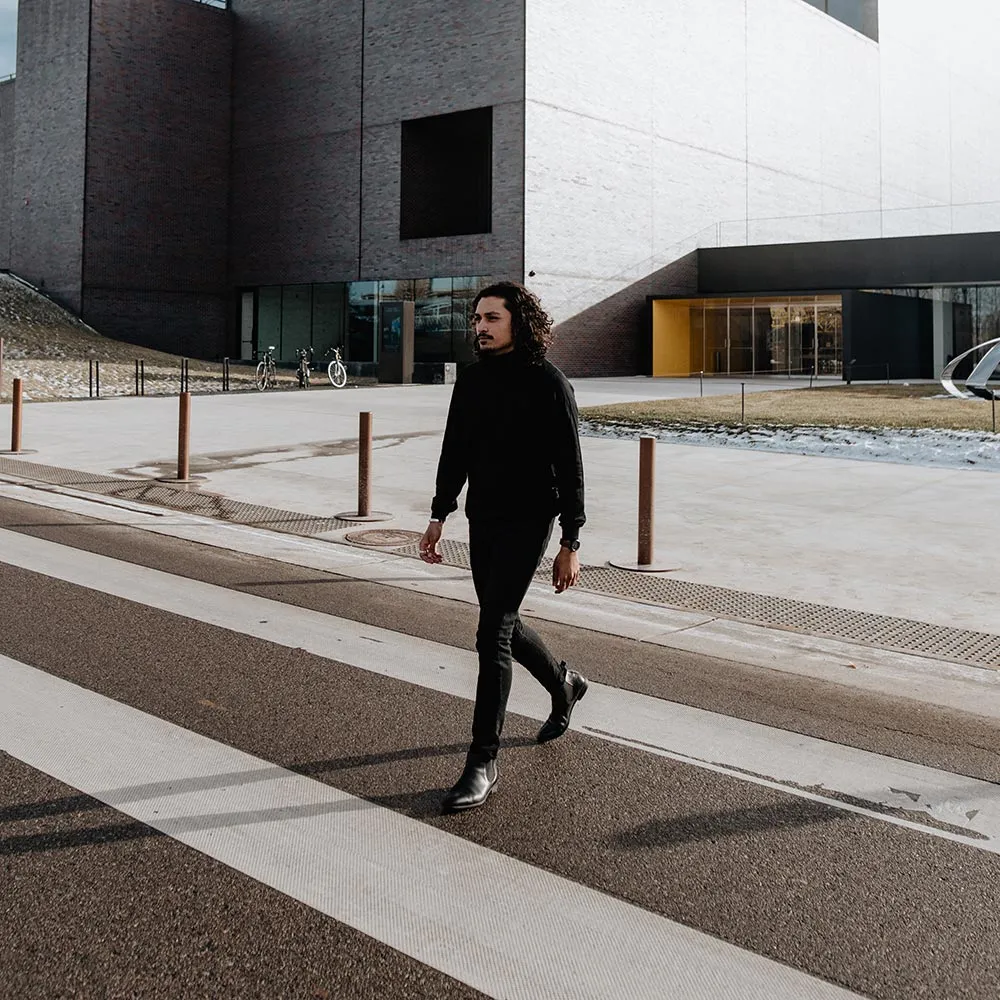 Crossing a wide street in all black, a black Aspect on brown leather